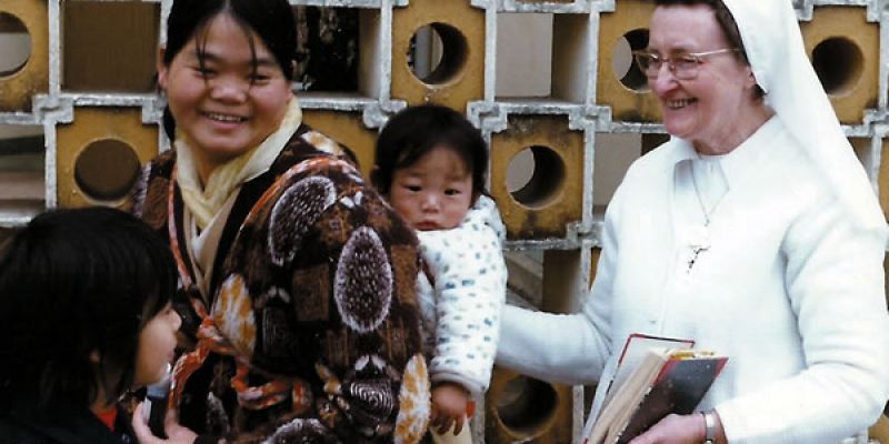 Sr. Damien with a mother and child at the Caritas Center in Fanling.