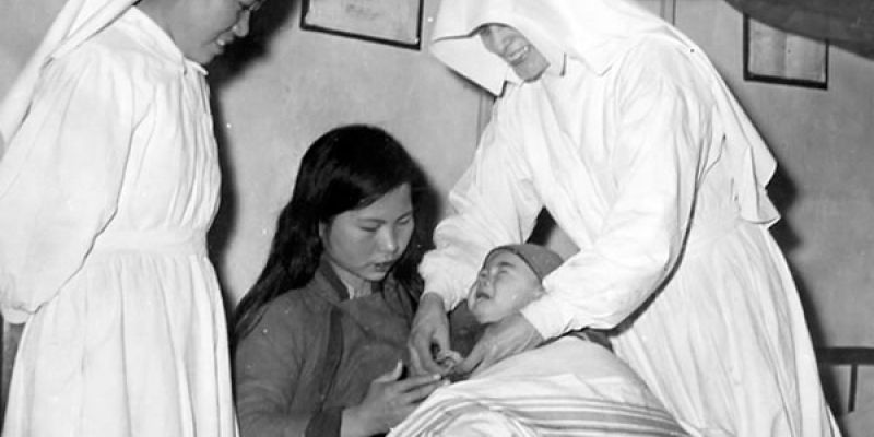 Two Sisters helping a mother with her baby in China