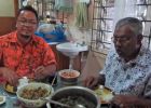 Fr. Kurt eating lunch with Uncle Bale